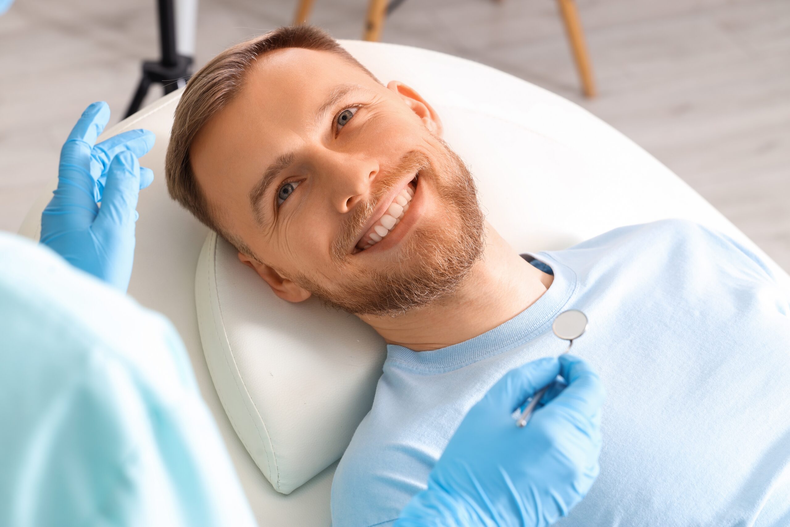 closeup of a young man smiling in a dental chair